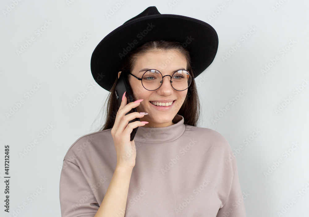 Portrait of a smiling young casual brunette woman talking on mobile phone isolated over white background Portrait of a smiling young casual brunette woman talking on mobile phone isolated over white background