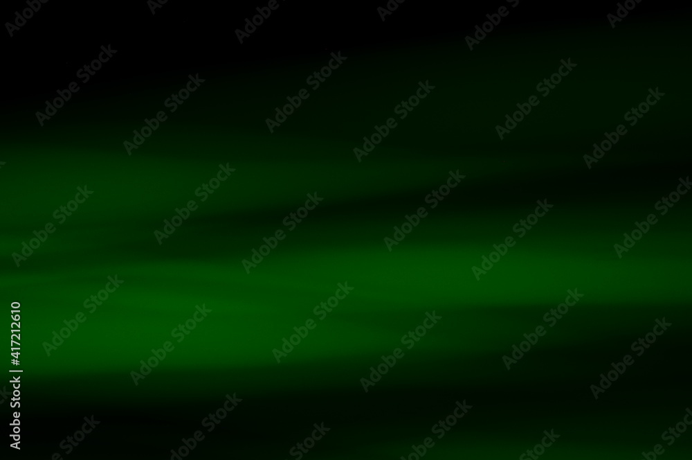 Obraz premium Green abstract background - lines and streaks of light. Blurred, irregular light elements on black background. Green fanciful 3d patterns.