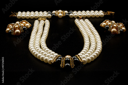 Beautiful pearl necklace on black background