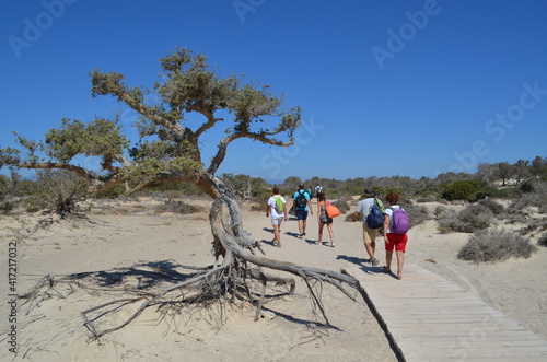 Group of tourists walking on Chrissi island, Greece photo