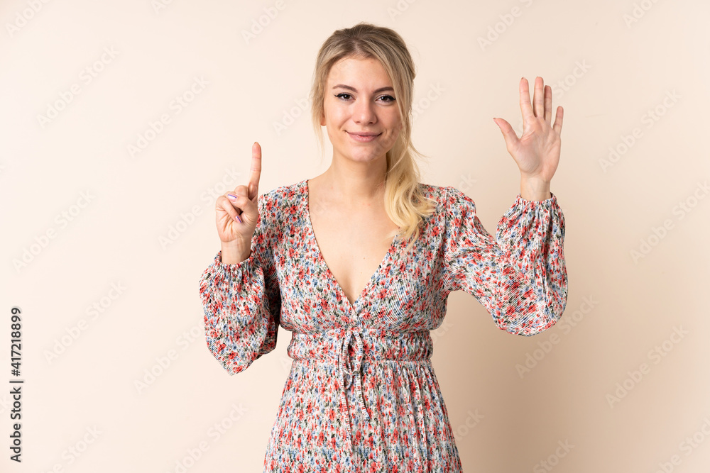 Blonde woman over isolated background counting seven with fingers Blonde woman over isolated background counting seven with fingers