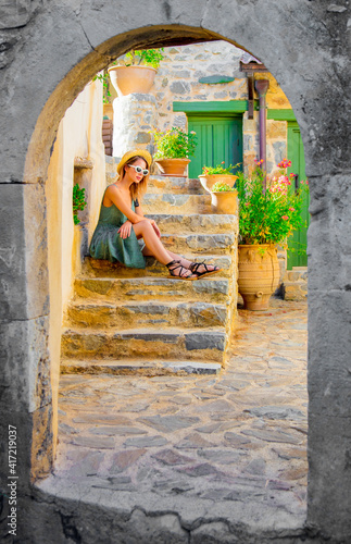girl on little village street on Crete, Greece © Masson