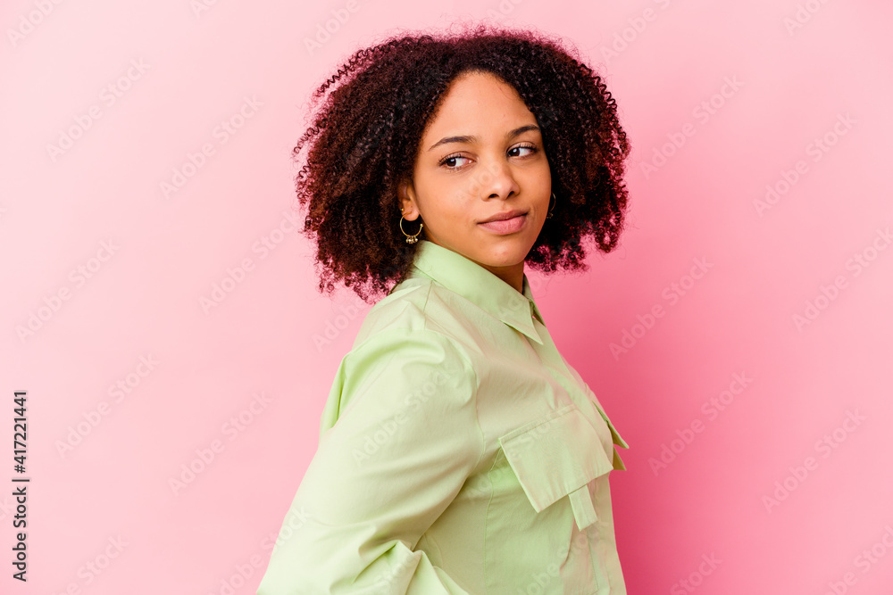 Young african american mixed race woman isolated looks aside smiling, cheerful and pleasant. Young african american mixed race woman isolated looks aside smiling, cheerful and pleasant.