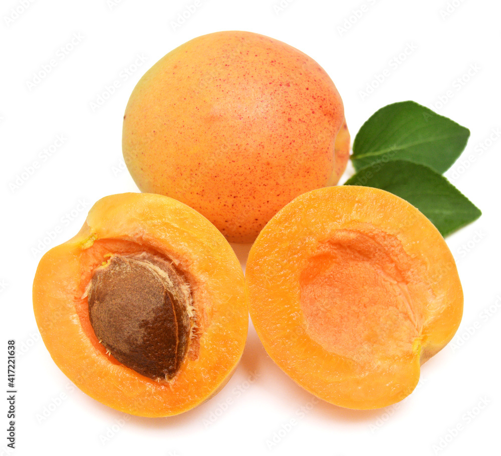 Apricot fruit whole and half with leaf isolated on white background. Flat lay, top view