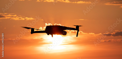 Quadcopter or drone on a sunset background