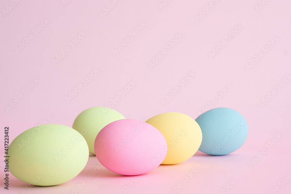 Easter eggs pastel colors on pink background with copy space . Greeting card and advertising concept . Easter eggs pastel colors on pink background with copy space . Greeting card and advertising concept .