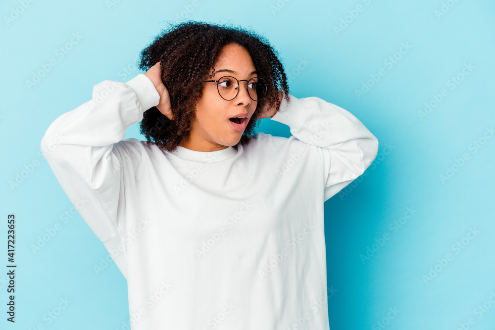 Young african american mixed race woman isolated pointing to different copy spaces, choosing one of them, showing with finger. Young african american mixed race woman isolated pointing to different copy spaces, choosing one of them, showing with finger.