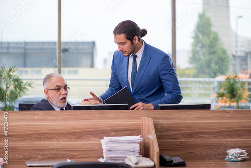 Two businessmen employees working in the office