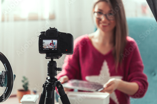 woman blogger makes video of unpacking gadgets at home