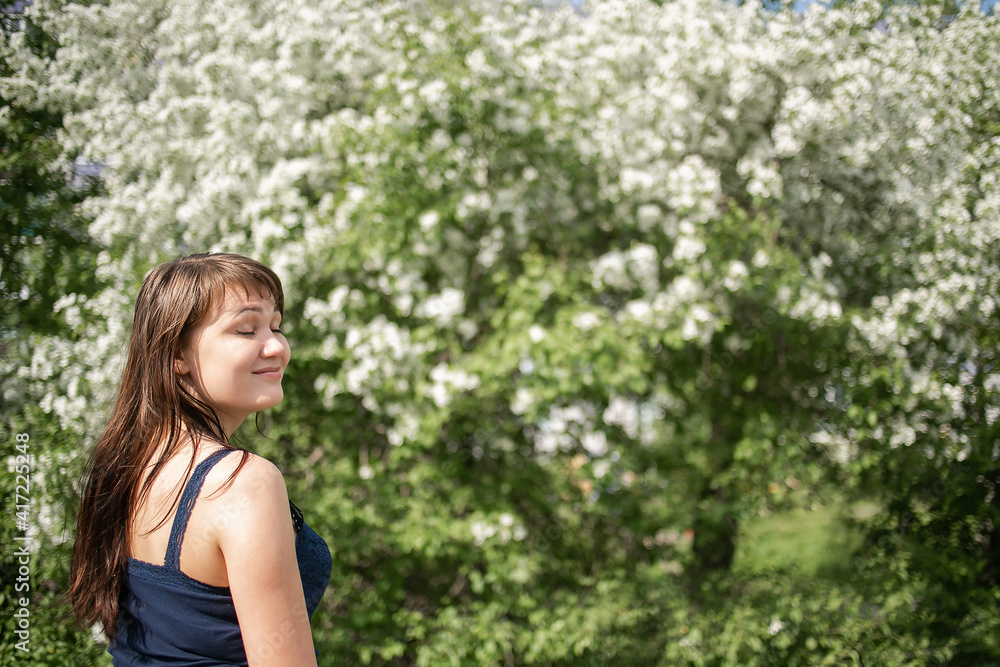 Spring mood, cute woman smell flowering trees, enjoying nature, white floral garden, apple trees warm clear good weather. Spring mood, cute woman smell flowering trees, enjoying nature, white floral garden, apple trees warm clear good weather.