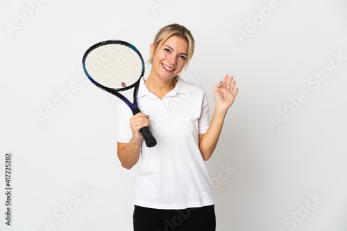 Young Russian woman tennis player isolated on white background saluting with hand with happy expression