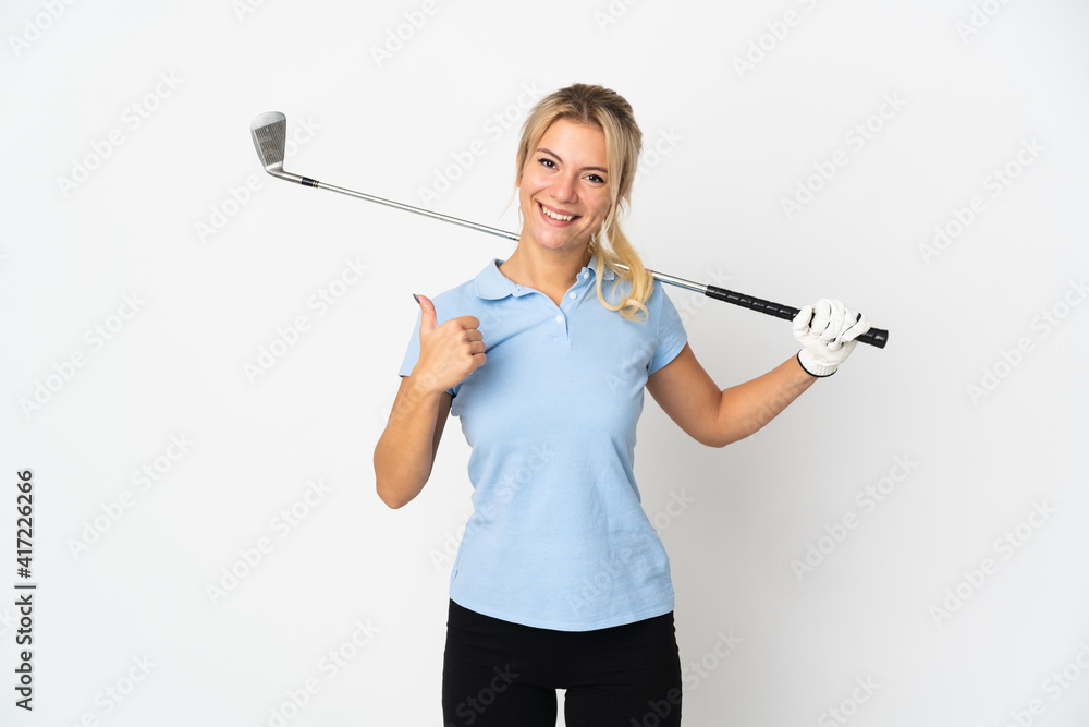Young Russian woman isolated on white background playing golf and with thumbs up because something good has happened Young Russian woman isolated on white background playing golf and with thumbs up because something good has happened