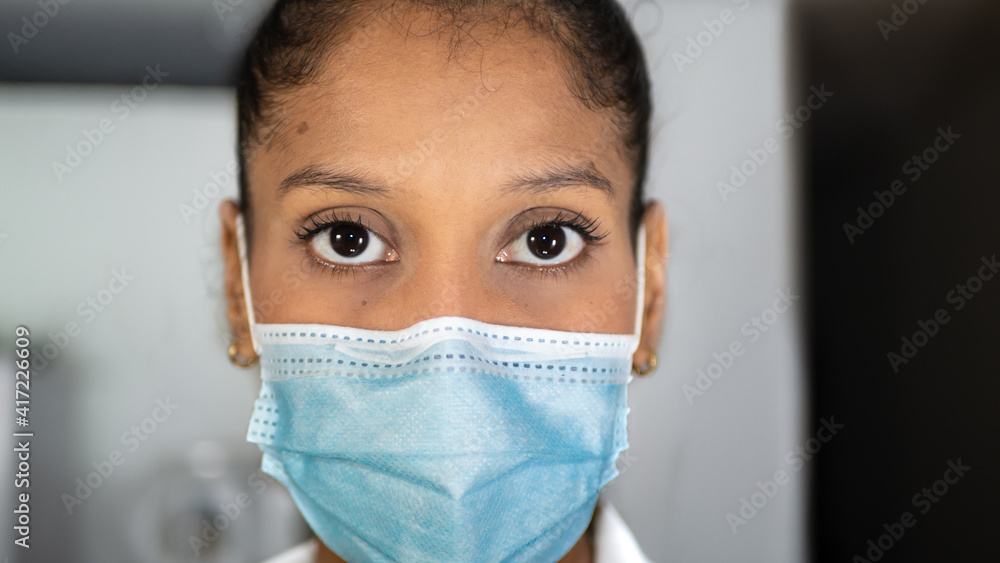 Close-up of a brunette woman with surgical or medicine mask that protects herself from any toxic virus and covid Close-up of a brunette woman with surgical or medicine mask that protects herself from any toxic virus and covid