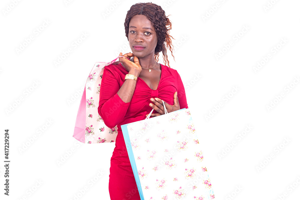 portrait of a beautiful young african woman carrying shopping bags. portrait of a beautiful young african woman carrying shopping bags.