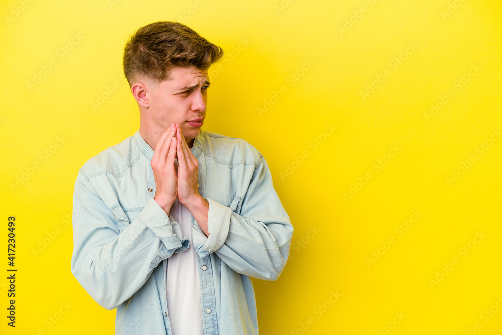Young caucasian man isolated on yellow background making up plan in mind, setting up an idea. Young caucasian man isolated on yellow background making up plan in mind, setting up an idea.