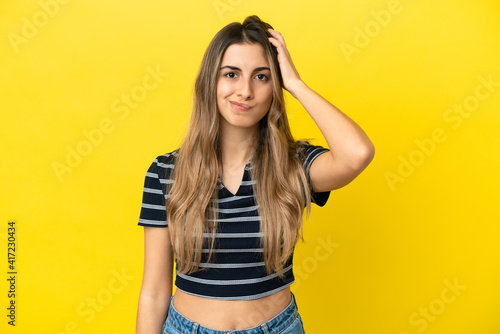 Young caucasian woman isolated on yellow background with an expression of frustration and not understanding