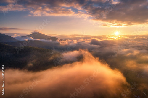 Mountains in clouds at sunr...
