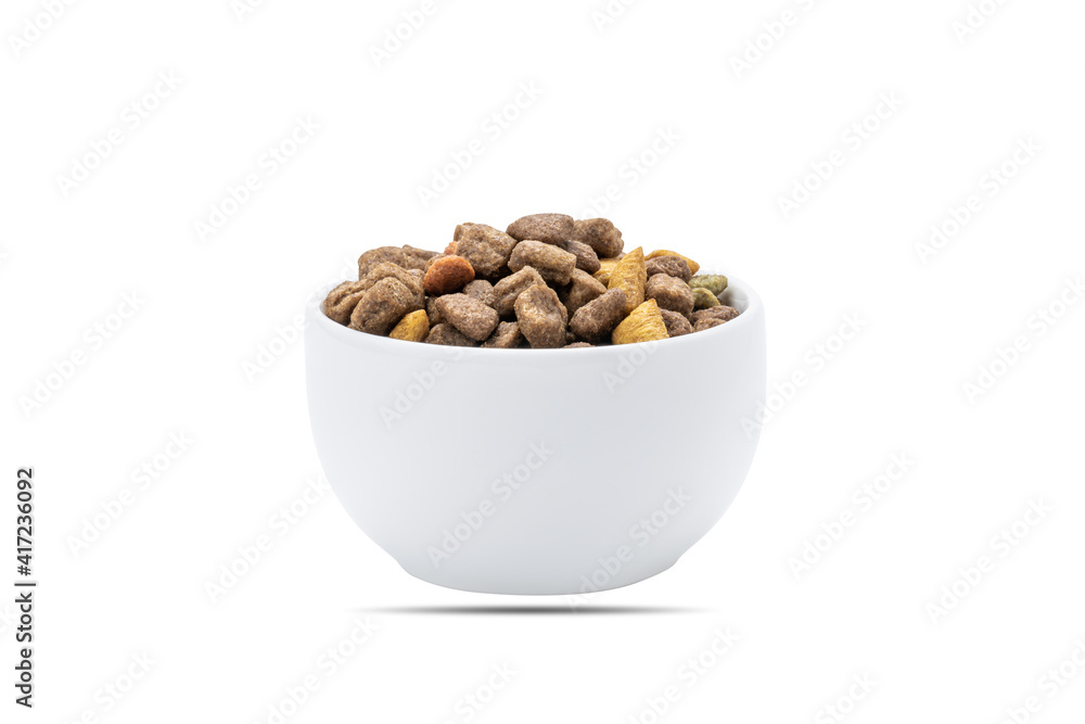 domestic animals dry food at white bowl isolated on white background. dried cat feed cut out. above view domestic animals dry food at white bowl isolated on white background. dried cat feed cut out. above view
