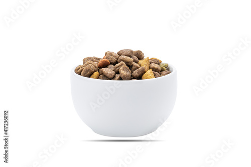 Fototapeta Naklejka Na Ścianę i Meble -  domestic animals dry food at white bowl isolated on white background. dried cat feed cut out. above view