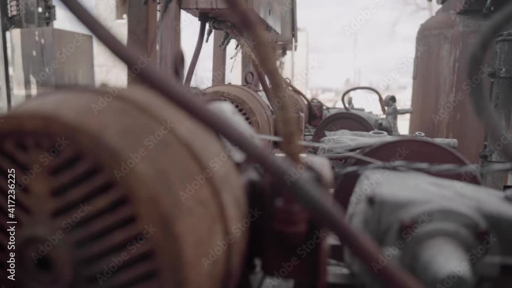Row of Old Pressure Washer Engines Covered in Rust at an Abandoned Car