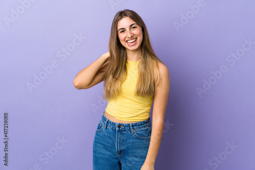 Young woman over isolated purple background laughing