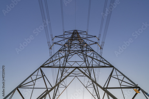 Electricity Pylon carrying electric power across the united kingdom. Large steel tower high above the landscape. Expensive electricity power grid. 
