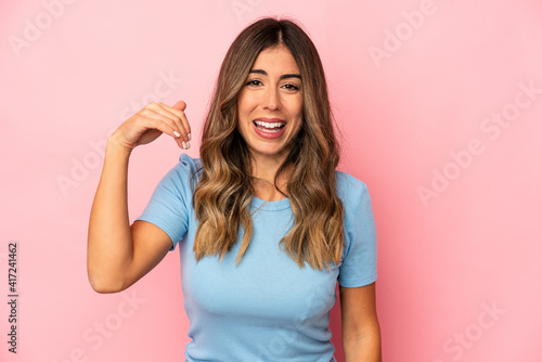 Young caucasian woman isolated laughing about something, covering mouth with hands.