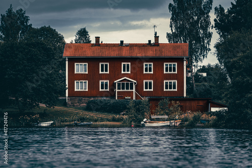 Moody dark swedish house on a lake at the water