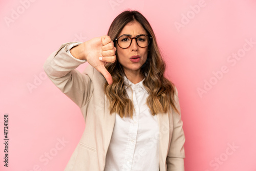 Young caucasian woman isolated showing thumb down and expressing dislike.