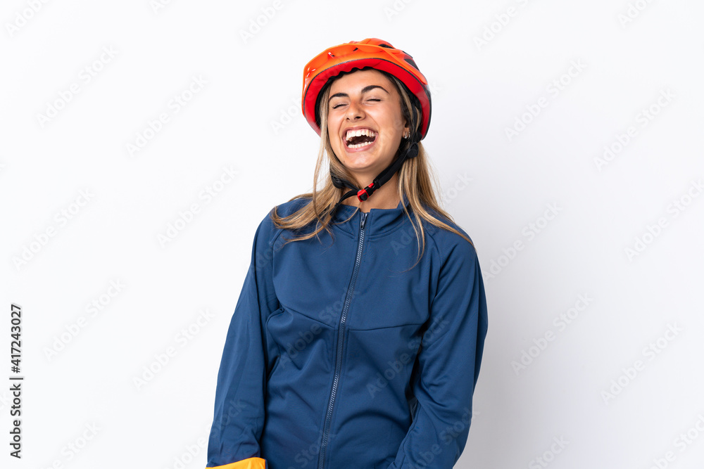 Young hispanic cyclist woman isolated on white background laughing Young hispanic cyclist woman isolated on white background laughing
