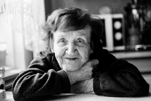 Portrait of an old woman in her home. Black and white photo. © De Visu