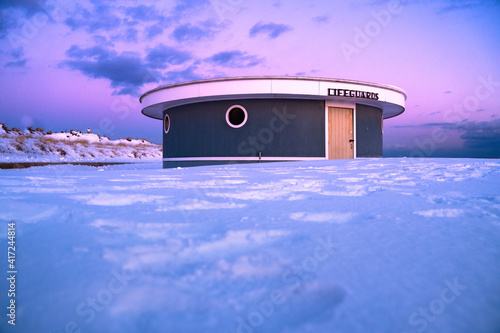 Winter scene under color sky at sunset on snow covered beach. Jones Beach State Park., Long Island NY photo