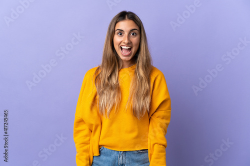 Young hispanic woman over isolated purple background with surprise facial expression © luismolinero