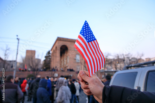 man holding American flag in the demonstration