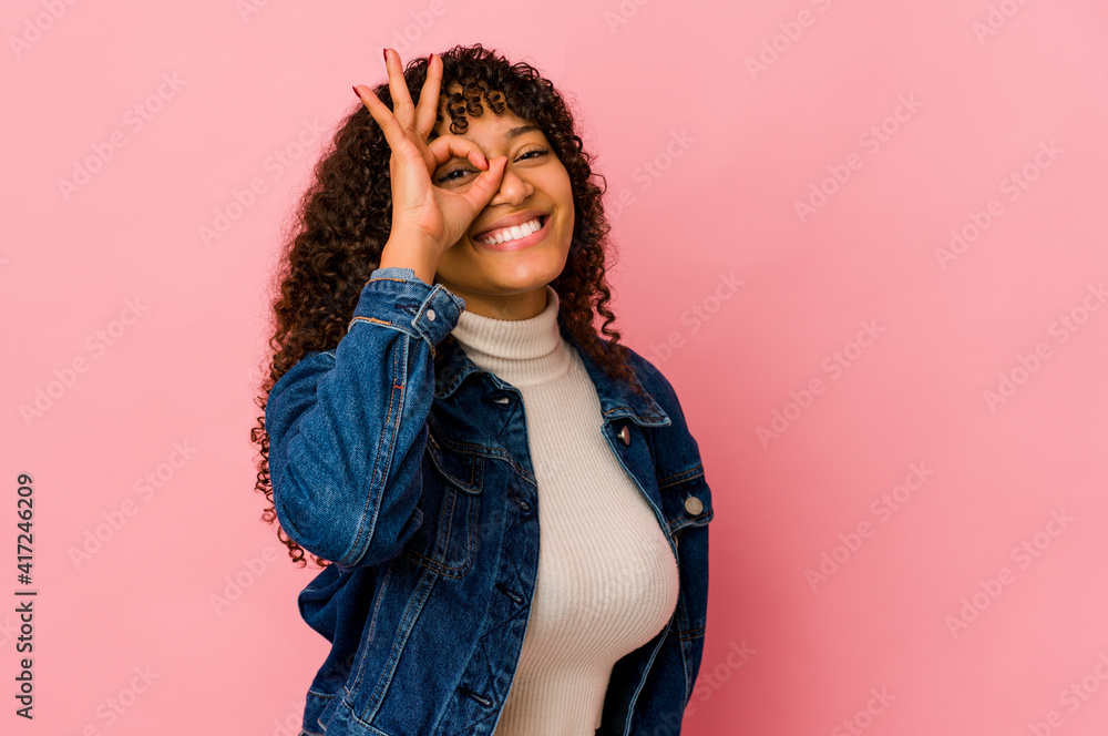 Young african american afro woman isolated excited keeping ok gesture on eye. Young african american afro woman isolated excited keeping ok gesture on eye.