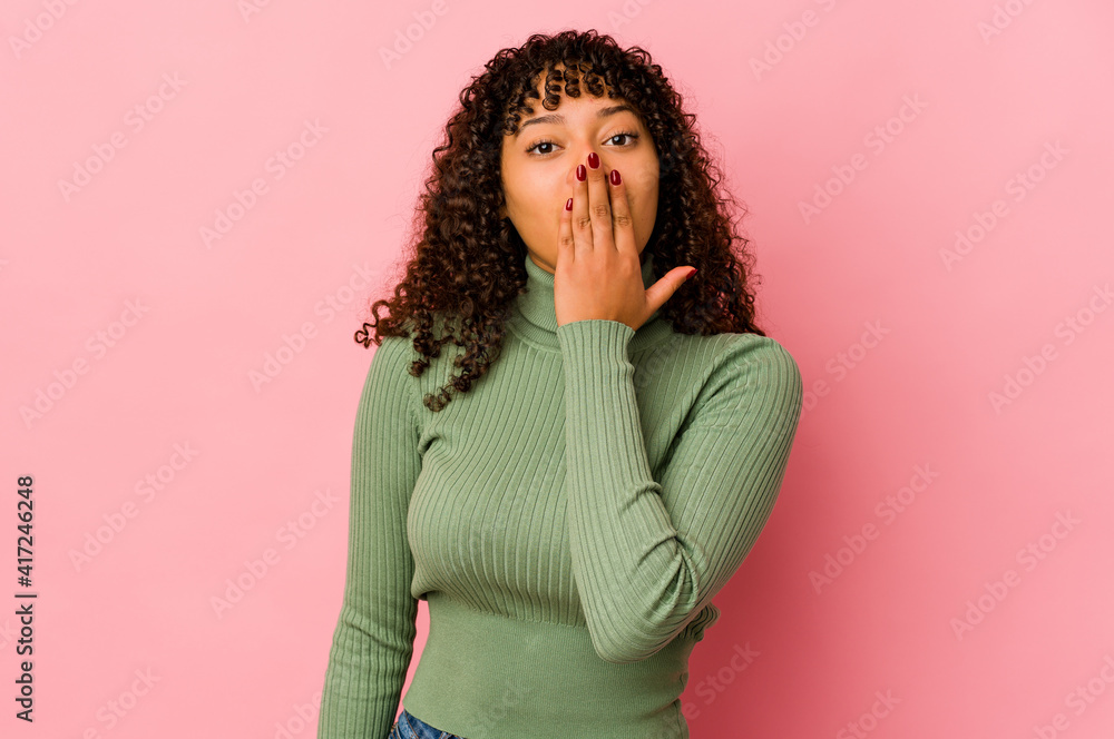 Young african american afro woman isolated shocked, covering mouth with hands, anxious to discover something new. Young african american afro woman isolated shocked, covering mouth with hands, anxious to discover something new.