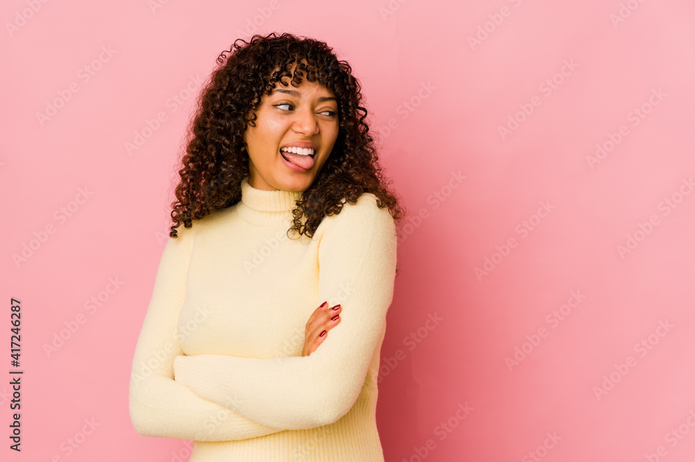 Young african american afro woman isolated funny and friendly sticking out tongue. Young african american afro woman isolated funny and friendly sticking out tongue.