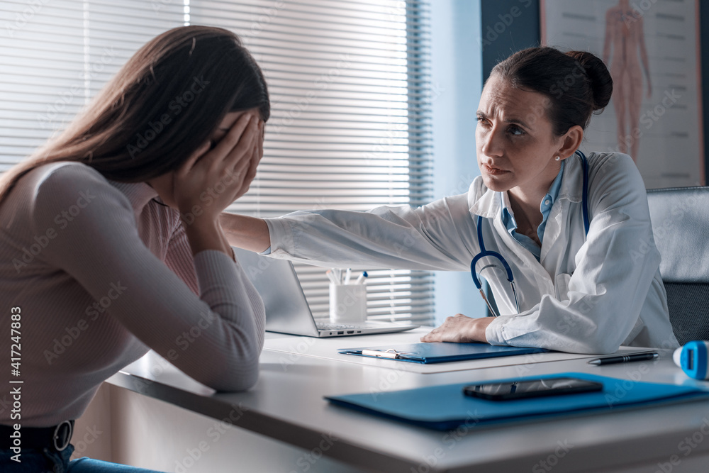 Doctor assisting a crying patient in the office Stock Photo Adobe Stock