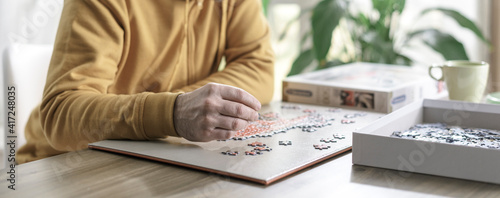 Man solving a puzzle at home