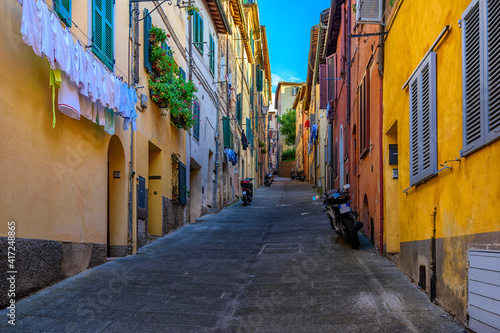 Medieval narrow street in Siena, Tuscany, Italy. Architecture and landmark of Siena. Cozy cityscape of Siena