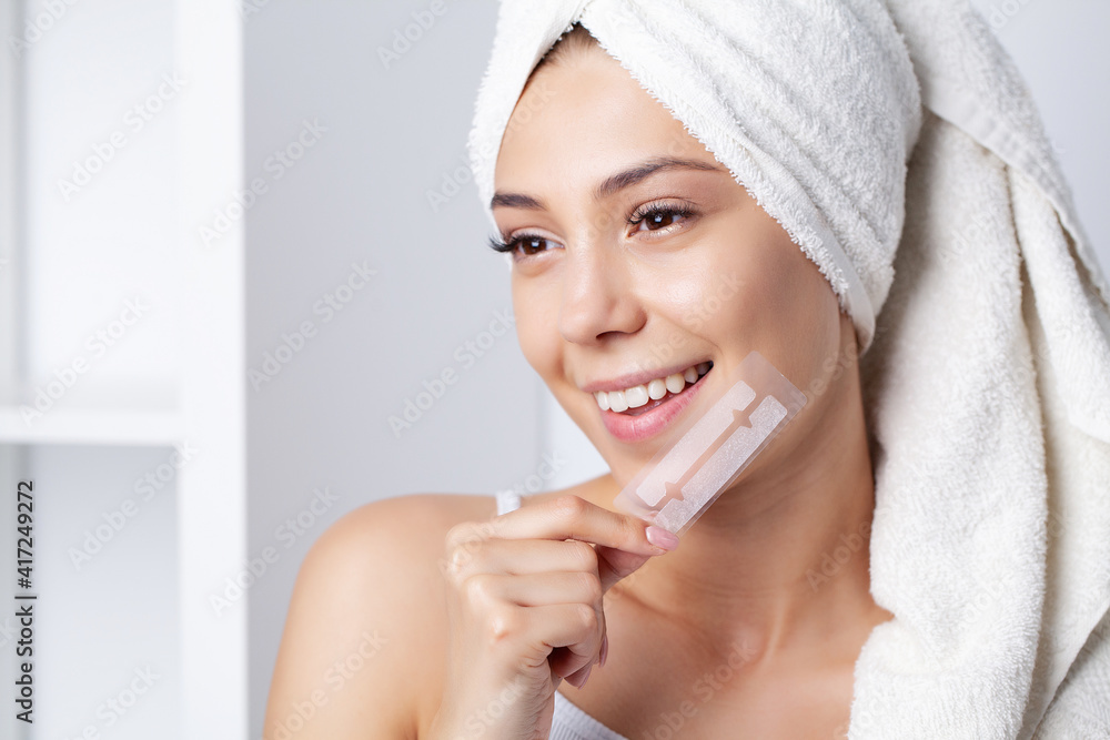 Beautiful Young Girl With White Teeth Holding in Hands Stripes For Teeth Whitening. Beautiful Young Girl With White Teeth Holding in Hands Stripes For Teeth Whitening.