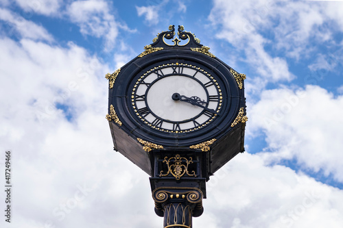 Big clock in the city centre of Stourbridge on sunny day .  Big clock on the blue sky in United Kingdom