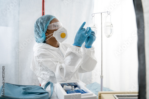Medical worker preparing to the dropper during coronavirus pandemic