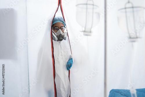 Female doctor in a protective cap and face mask in safety measures