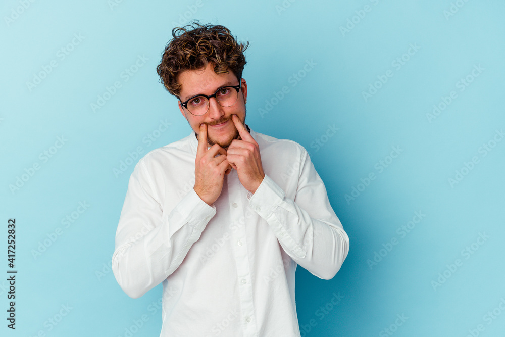 Young caucasian business man isolated on blue background doubting between two options. Young caucasian business man isolated on blue background doubting between two options.