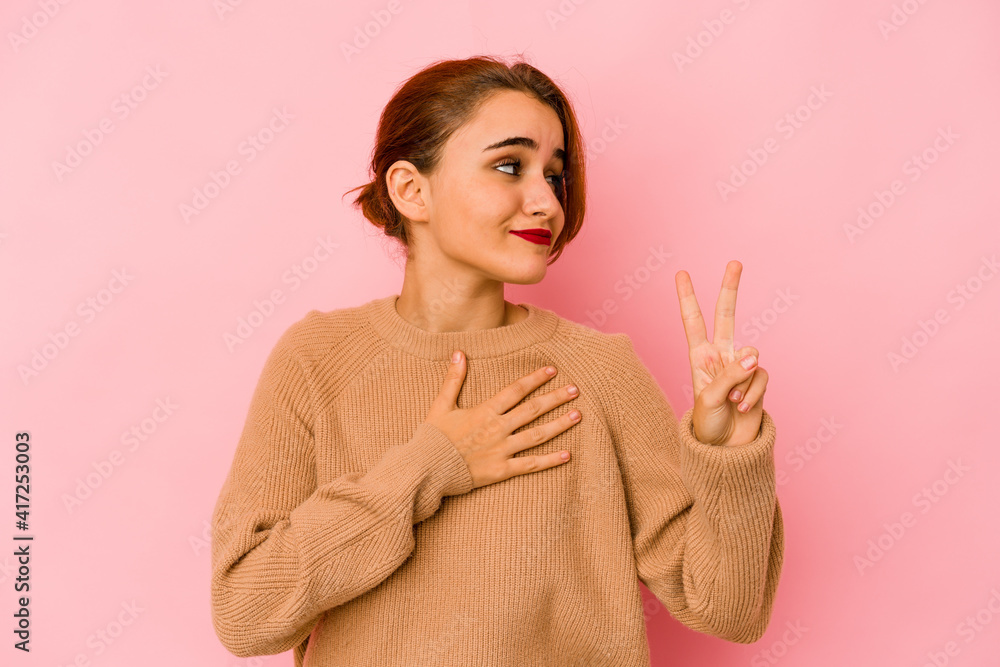Young arab mixed race woman taking an oath, putting hand on chest. Young arab mixed race woman taking an oath, putting hand on chest.