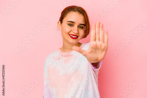 Young arab mixed race woman smiling cheerful showing number five with fingers.