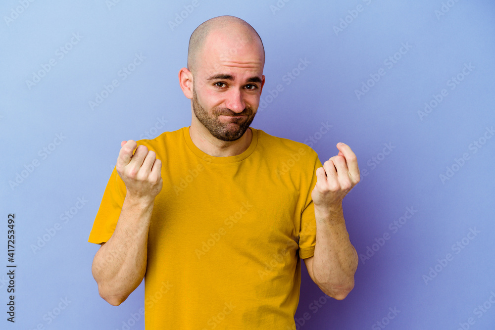 Young caucasian bald man isolated on purple background showing that she has no money. Young caucasian bald man isolated on purple background showing that she has no money.