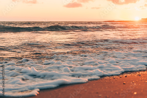 Fototapeta Naklejka Na Ścianę i Meble -  Sea wave with foam under beautiful sunset
