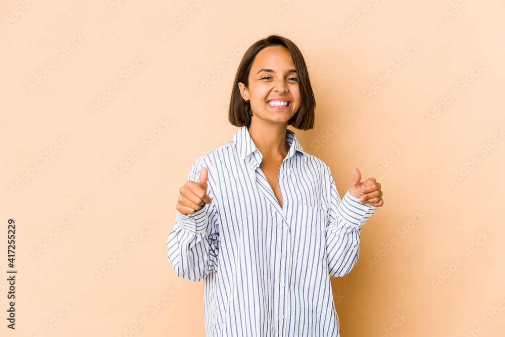 Young hispanic woman isolated raising both thumbs up, smiling and confident. Young hispanic woman isolated raising both thumbs up, smiling and confident.